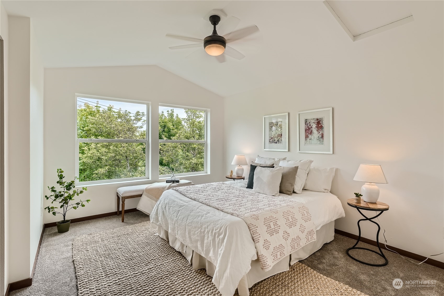 4313 South Webster Street, Unit B Seattle, WA 98118 - Photo 17 of 26 a bedroom with a large bed and a chandelier fan