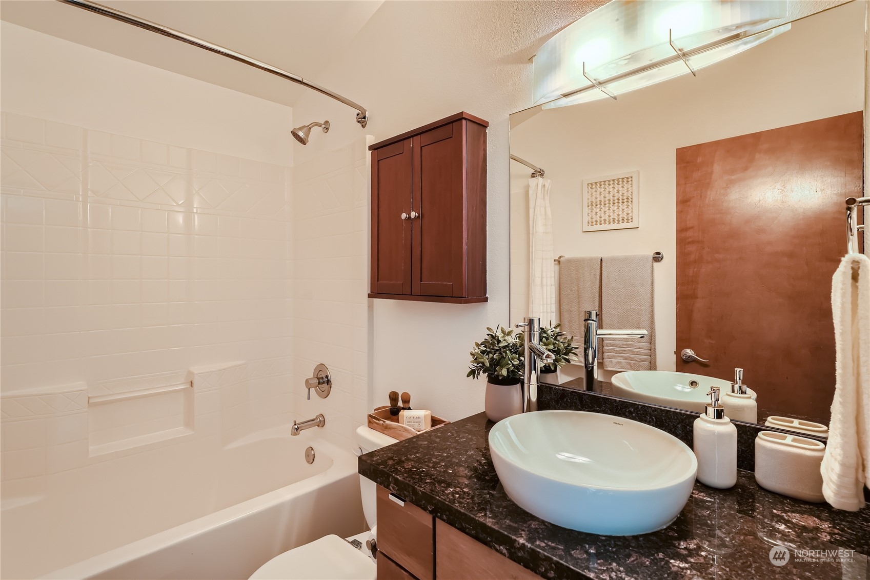 4313 South Webster Street, Unit B Seattle, WA 98118 - Photo 20 of 26 a bathroom with a granite countertop sink and a mirror