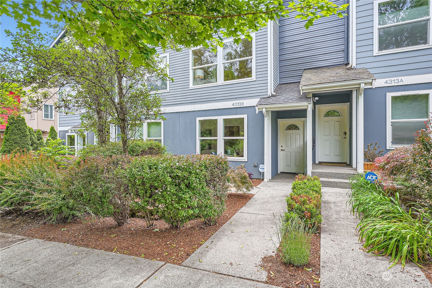 4313 South Webster Street, Unit B Seattle, WA 98118 - Photo 2 of 26 front view of a house with a yard