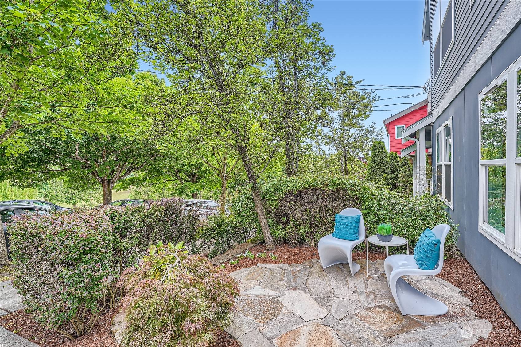 4313 South Webster Street, Unit B Seattle, WA 98118 - Photo 3 of 26 a view of a chair and table in backyard of the house