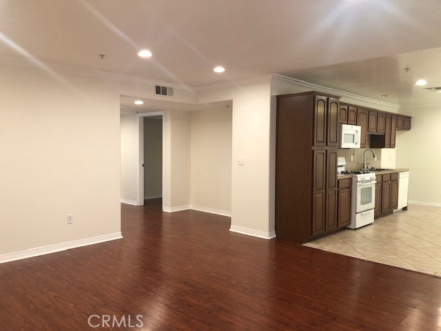 13525 Vanowen Street, Unit 102 Van Nuys, CA 91405 - Photo 4 of 13 a view of a kitchen with wooden floor