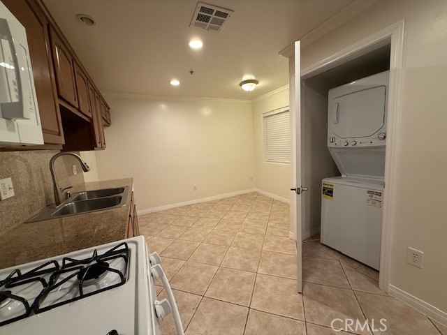 13525 Vanowen Street, Unit 102 Van Nuys, CA 91405 - Photo 7 of 13 a view of a kitchen with a sink wooden floor and a window