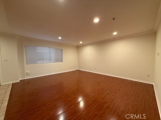 13525 Vanowen Street, Unit 102 Van Nuys, CA 91405 - Photo 8 of 13 an empty room with wooden floor and windows