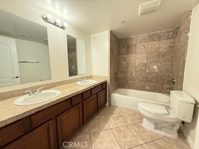 13525 Vanowen Street, Unit 102 Van Nuys, CA 91405 - Photo 9 of 13 a bathroom with a sink a toilet a mirror a bathtub and shower
