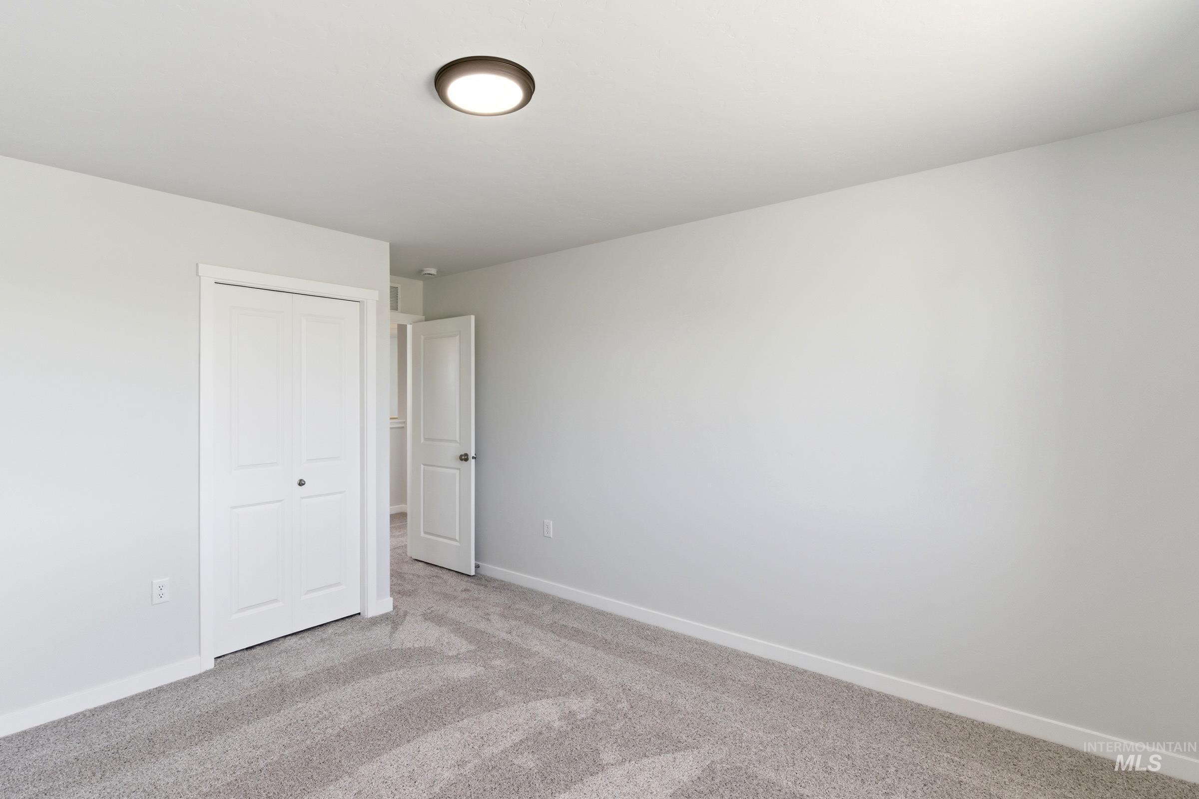13677 Redway Court Caldwell, ID 83607 - Photo 30 of 35 Room featuring light gray carpeting, white walls, and a flush-mount ceiling light fixture