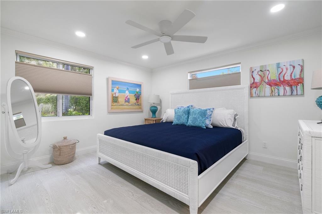 960 7th Street South, Unit 101 Naples, FL 34102 - Photo 7 of 11 a bed room with a bed and a couch