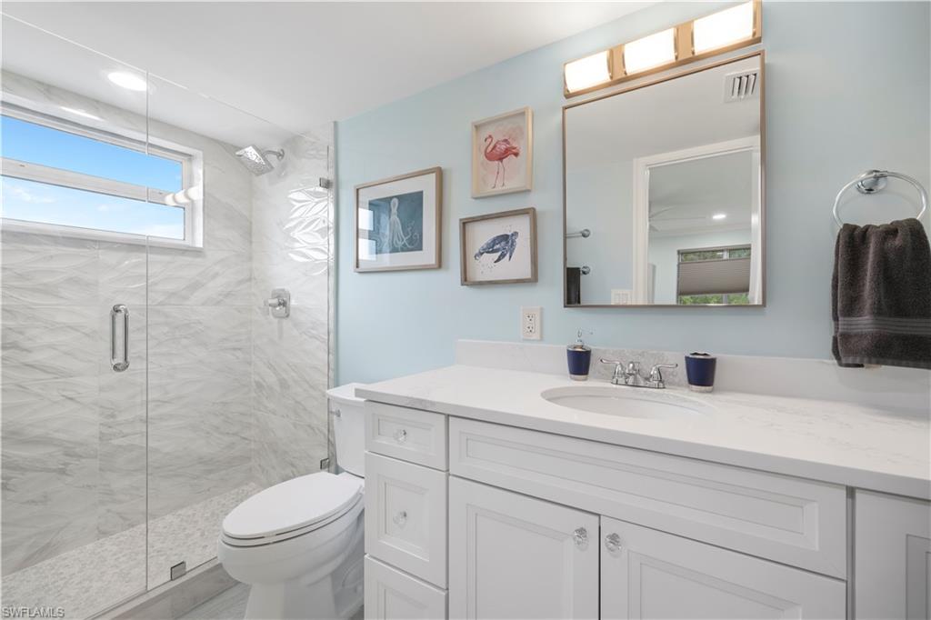 960 7th Street South, Unit 101 Naples, FL 34102 - Photo 8 of 11 a bathroom with a sink toilet and shower