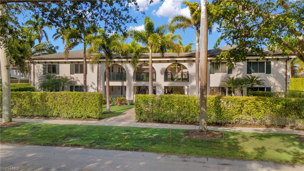 960 7th Street South, Unit 101 Naples, FL 34102 - Photo 9 of 11 front view of a house with a yard