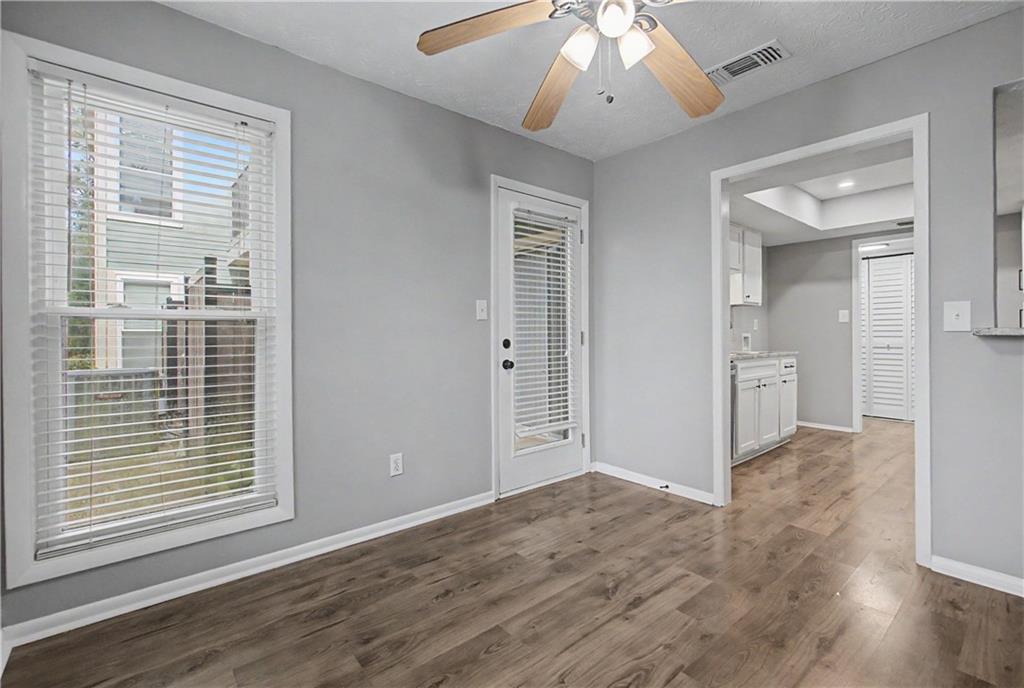 2011 Canyon Point Circle Roswell, GA 30076 - Photo 11 of 22 an empty room with wooden floor and windows