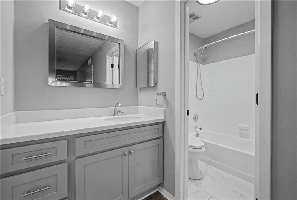 2011 Canyon Point Circle Roswell, GA 30076 - Photo 19 of 22 a bathroom with a shower sink and mirror