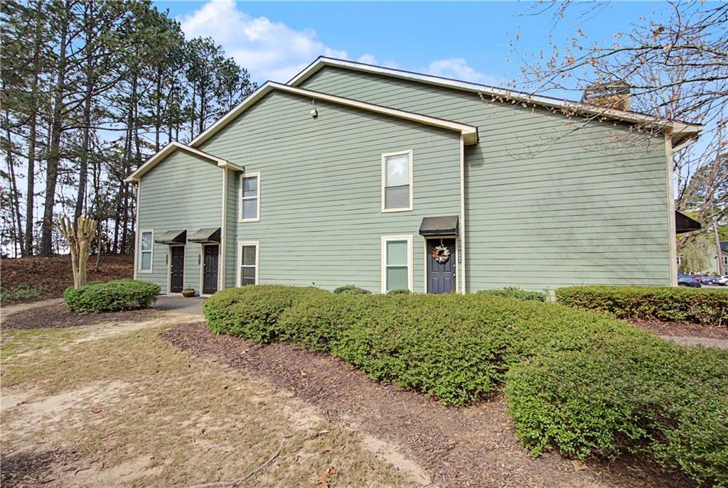 2011 Canyon Point Circle Roswell, GA 30076 - Photo 2 of 22 a front view of a house with a yard and garage