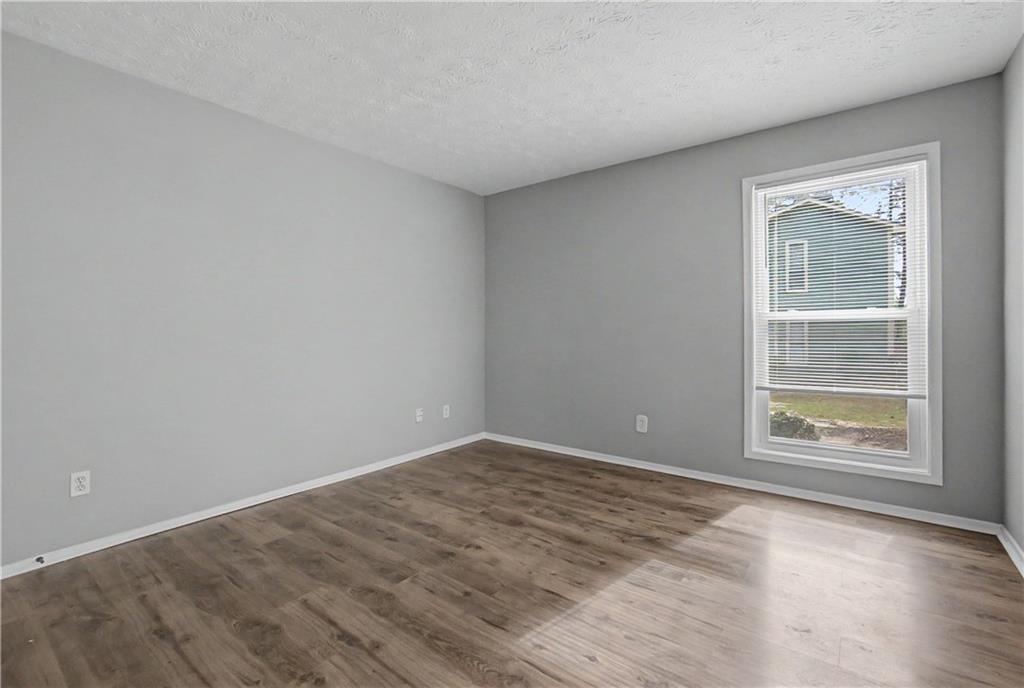 2011 Canyon Point Circle Roswell, GA 30076 - Photo 21 of 22 an empty room with wooden floor and windows