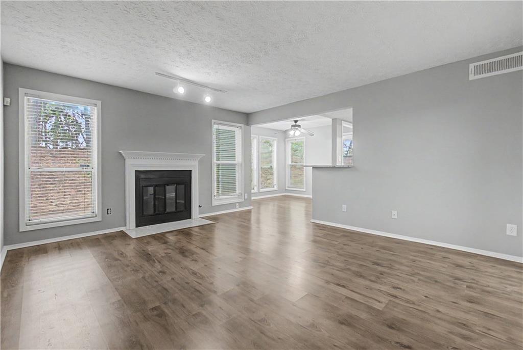 2011 Canyon Point Circle Roswell, GA 30076 - Photo 6 of 22 an empty room with wooden floor fireplace and windows