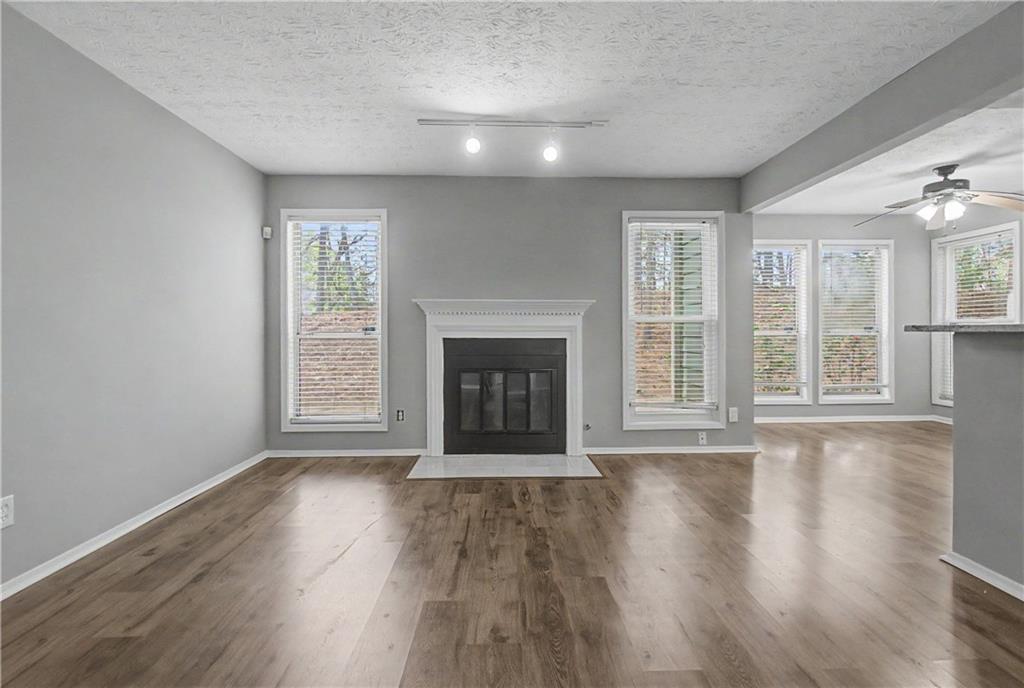 2011 Canyon Point Circle Roswell, GA 30076 - Photo 7 of 22 a view of an empty room with wooden floor and a window