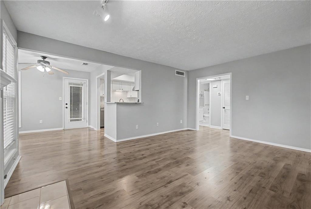 2011 Canyon Point Circle Roswell, GA 30076 - Photo 9 of 22 a view of an empty room with wooden floor and a window