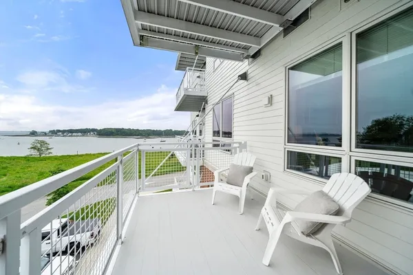 a view of a chairs and table in the balcony