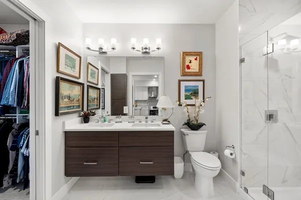 a bathroom with a toilet a sink and a mirror