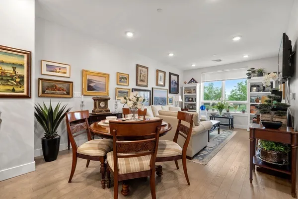 a living room with fireplace furniture and a potted plant