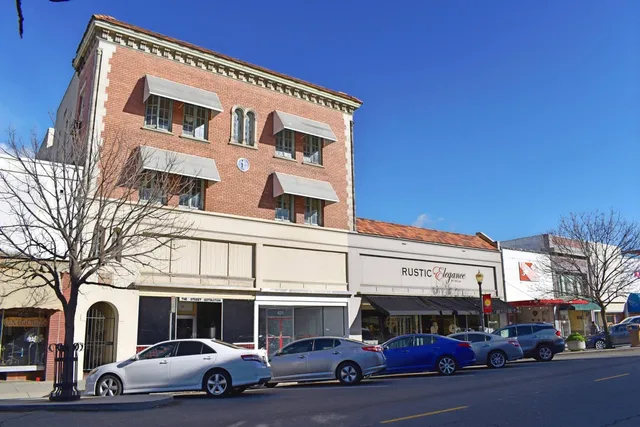 a couple of cars parked in front of a building