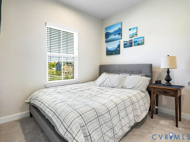 a bedroom with a bed and a lamp