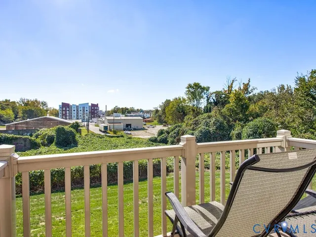 a view of a balcony with wooden fence and floor