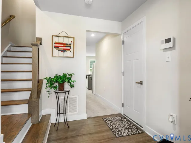 a room with a potted plant and wooden floor