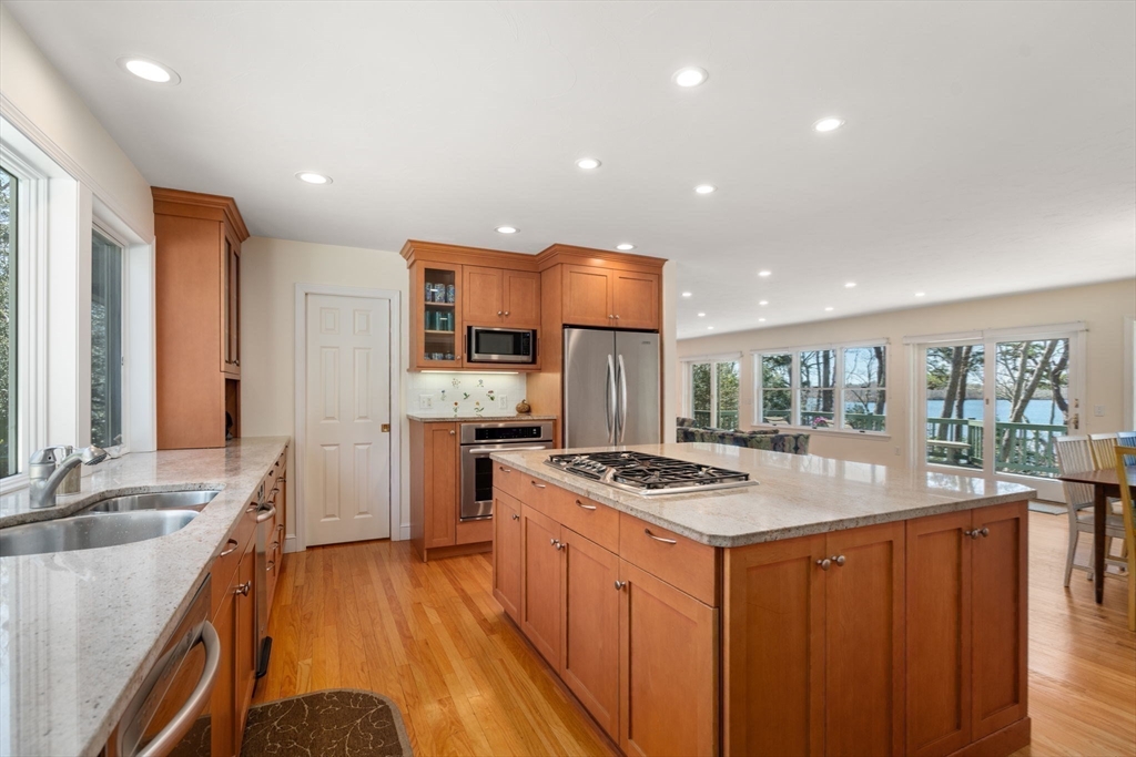 130 Pimlico Pond Road Mashpee, MA 02649 - Photo 14 of 39 a kitchen with stainless steel appliances sink stove refrigerator and cabinets