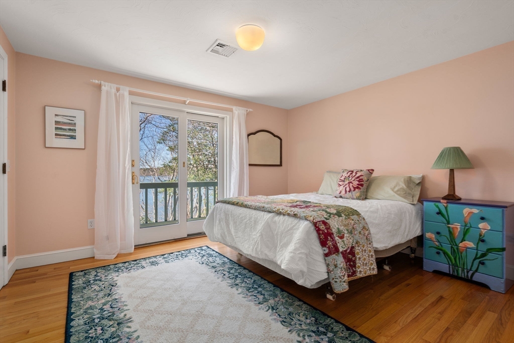 130 Pimlico Pond Road Mashpee, MA 02649 - Photo 22 of 39 a bed sitting in a bedroom next to a window