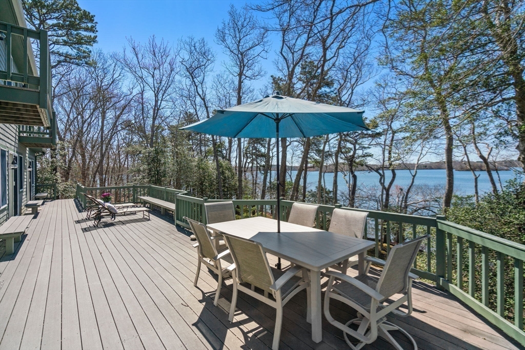 130 Pimlico Pond Road Mashpee, MA 02649 - Photo 27 of 39 a view of backyard with seating space and trees