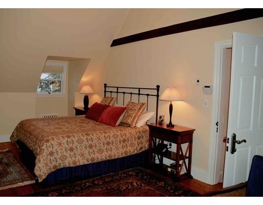 32 Chestnut Street Wellesley, MA 02481 - Photo 18 of 18 a bedroom with a bed a table and painting on the wall