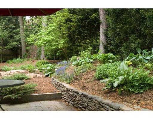 32 Chestnut Street Wellesley, MA 02481 - Photo 3 of 18 a view of a yard with plants and a bench