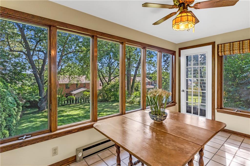 434 Summit Drive Pittsburgh, PA 15228 - Photo 11 of 24 a view of a dining room with furniture large windows and wooden floor