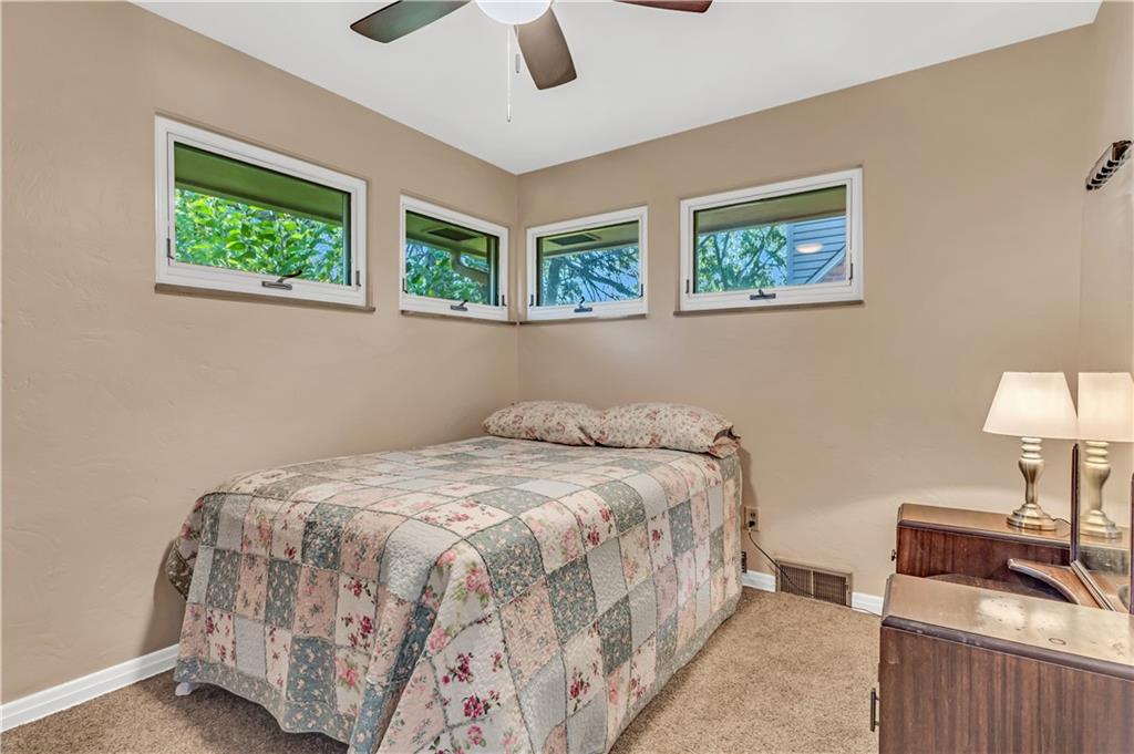 434 Summit Drive Pittsburgh, PA 15228 - Photo 12 of 24 a bedroom with a bed and a lamp on table