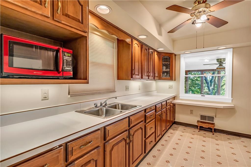 434 Summit Drive Pittsburgh, PA 15228 - Photo 8 of 24 a kitchen with stainless steel appliances a sink and a refrigerator