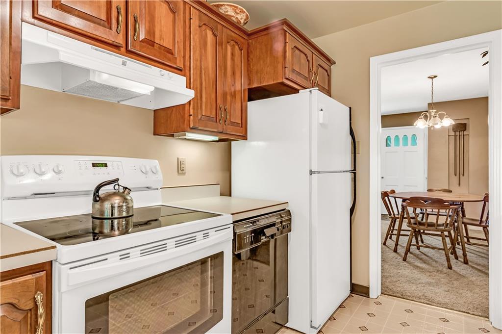 434 Summit Drive Pittsburgh, PA 15228 - Photo 10 of 24 a kitchen with stainless steel appliances a stove a refrigerator and a cabinets