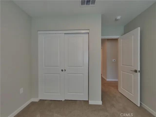 a view of a small space with wooden floor and a window