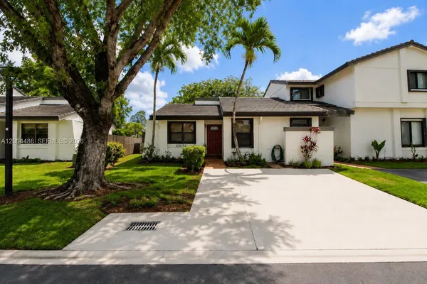 a front view of a house with a garden