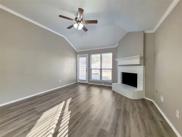 wooden floor in an empty room with a fireplace