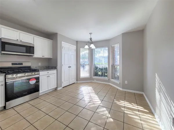 a kitchen with stainless steel appliances a stove a sink and a refrigerator