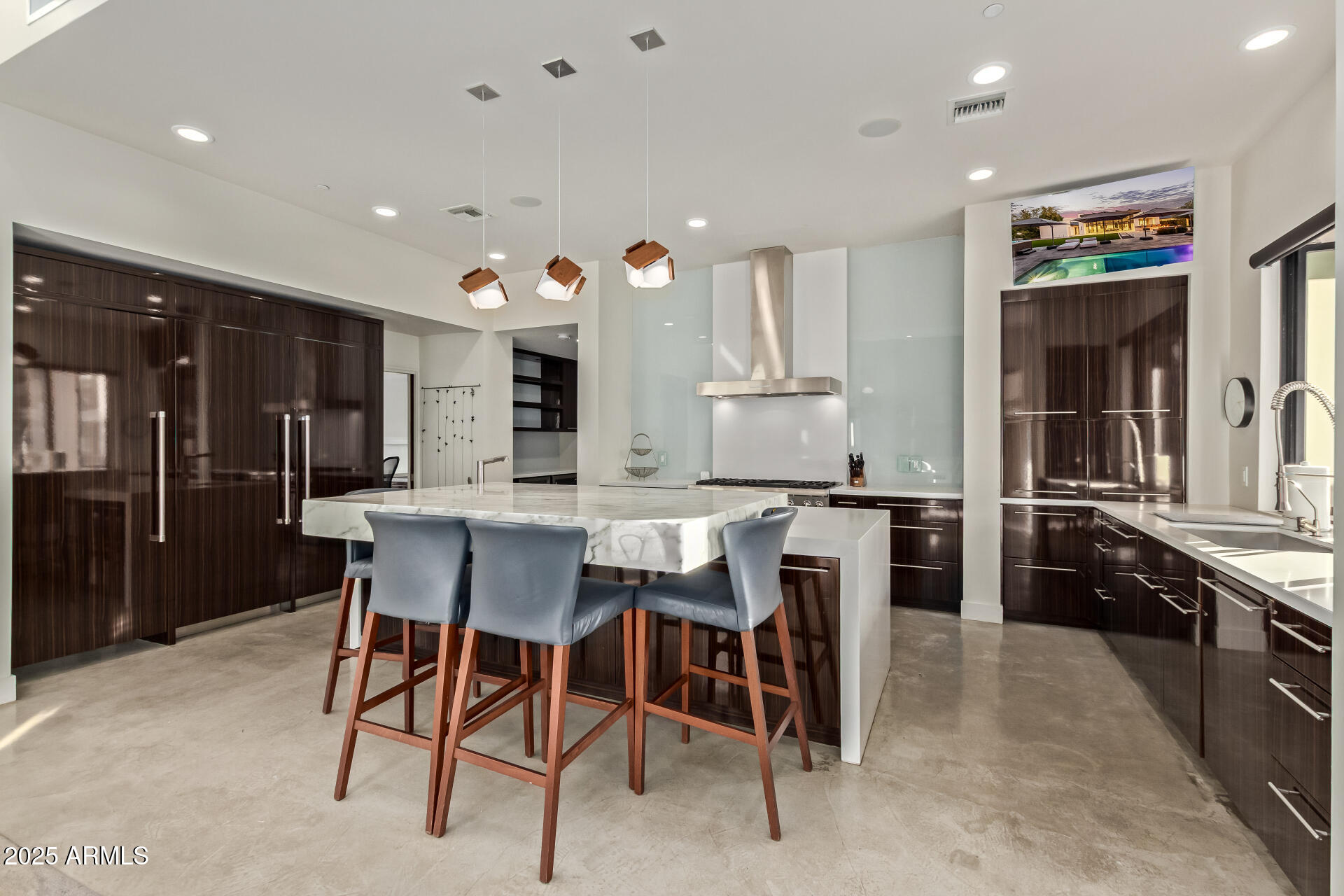 6636 North 48th Street Paradise Valley, AZ 85253 - Photo 15 of 54 a kitchen with stainless steel appliances kitchen island granite countertop a sink and cabinets