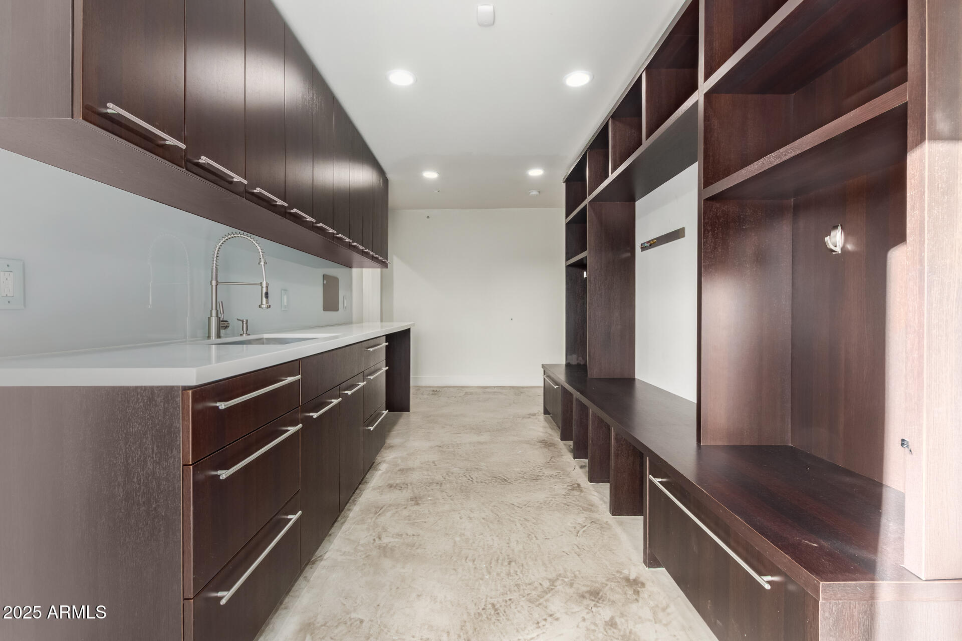 6636 North 48th Street Paradise Valley, AZ 85253 - Photo 37 of 54 a large kitchen with a large counter top space a sink and stainless steel appliances