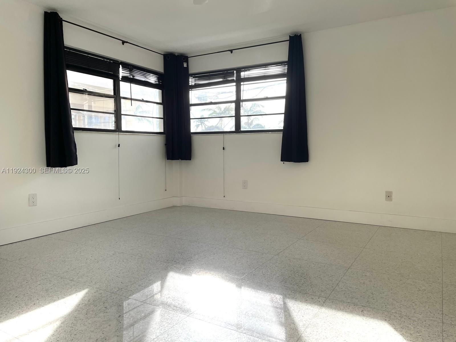 6424 Collins Avenue, Unit 204 Miami Beach, FL 33141 - Photo 16 of 21 wooden floor in an empty room with a window