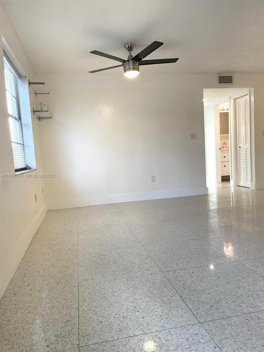 6424 Collins Avenue, Unit 204 Miami Beach, FL 33141 - Photo 6 of 21 an empty room with a ceiling fan and windows