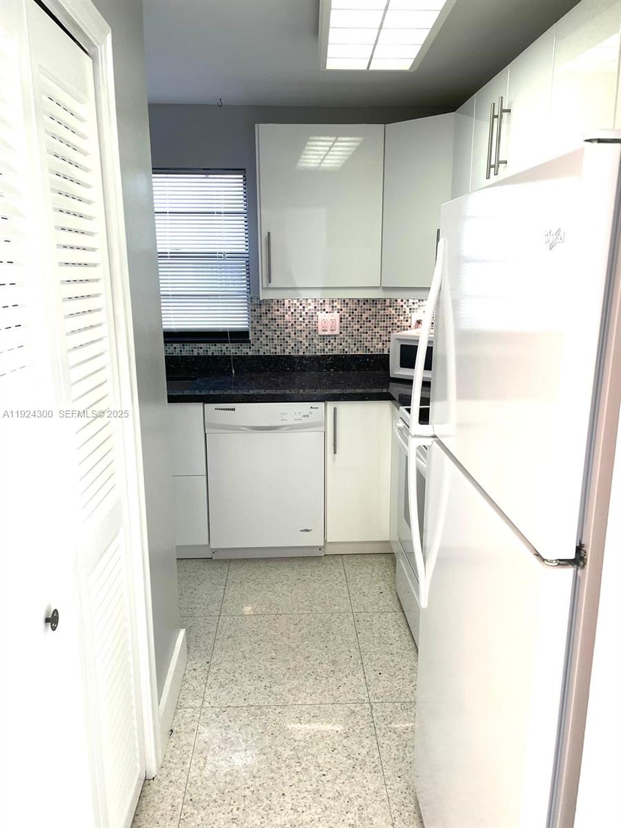 6424 Collins Avenue, Unit 204 Miami Beach, FL 33141 - Photo 8 of 21 a kitchen with a refrigerator a sink and dishwasher