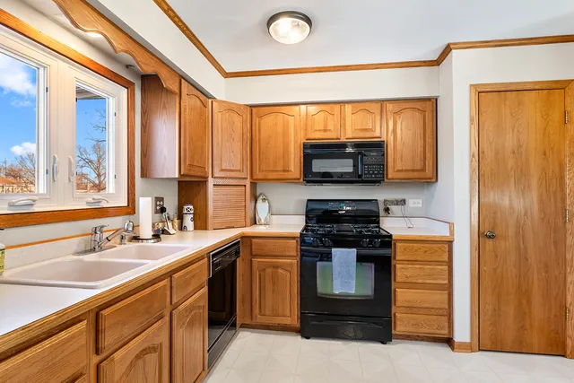 a kitchen with stainless steel appliances a stove sink and microwave