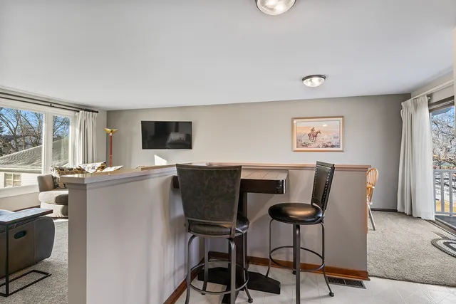 a view of a dining room with furniture and a window