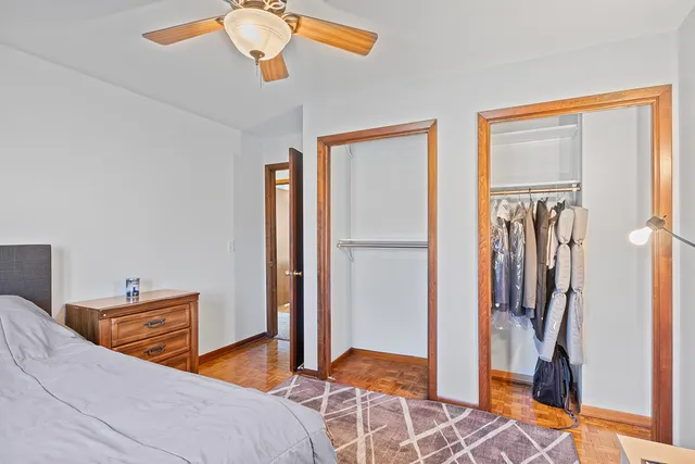 a bedroom with a bed and a refrigerator