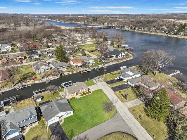 an aerial view of a house with a lake view