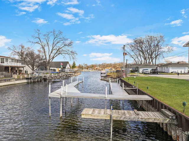 a swimming pool with outdoor seating and lake view