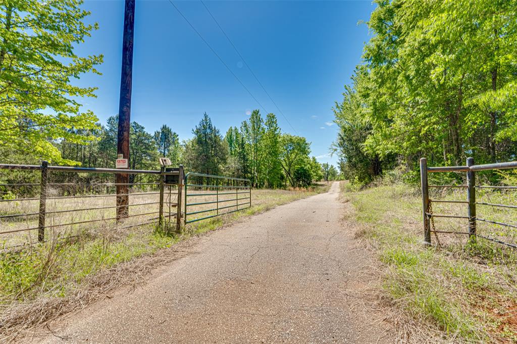 11088 County Road 334 Tyler, TX 75708 - Photo 3 of 23 a view of a yard with wooden fence